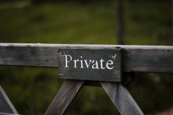 A gate with a sign that reads 'private'.